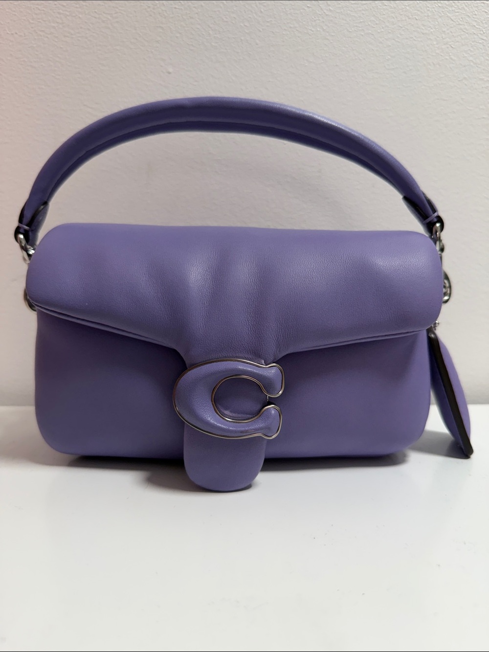 Coach Small Lavender Pillow Tabby with crossbody strap.